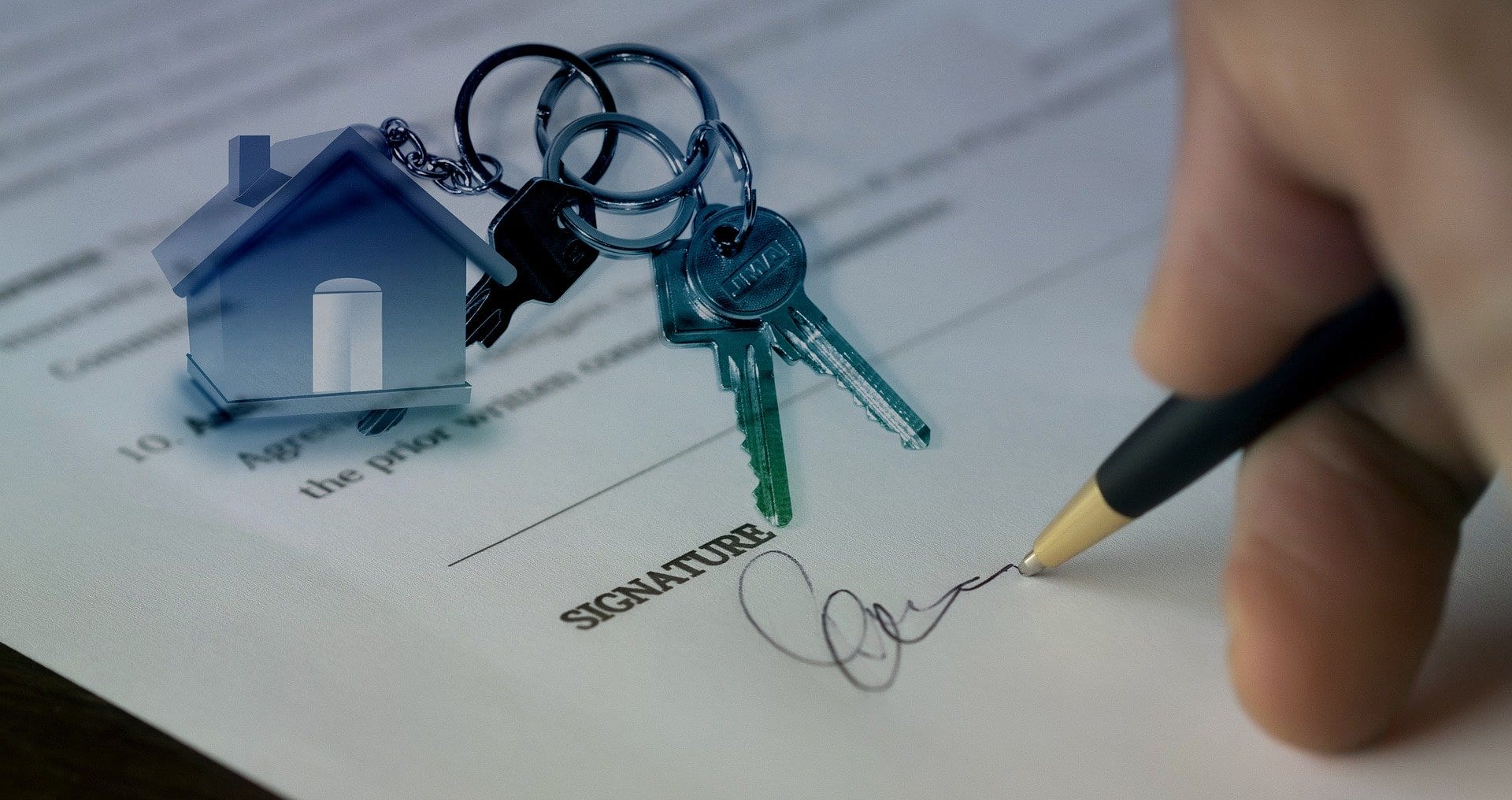 An investor signing an agreement after buying a house from an homeowner