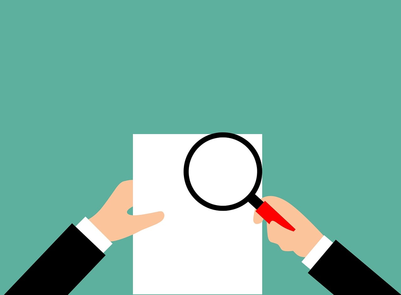 Magnifying glass and paper, inspection