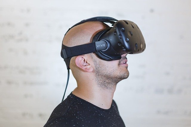 A man putting on a virtual reality headset and going through a VR tour of a house for sale