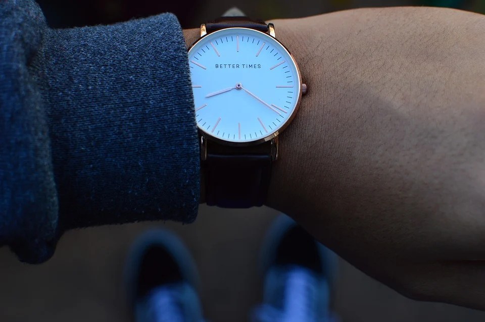 A home buyer looking at his wrist watch so he won't be late for an appointment with the agent during the home buying process