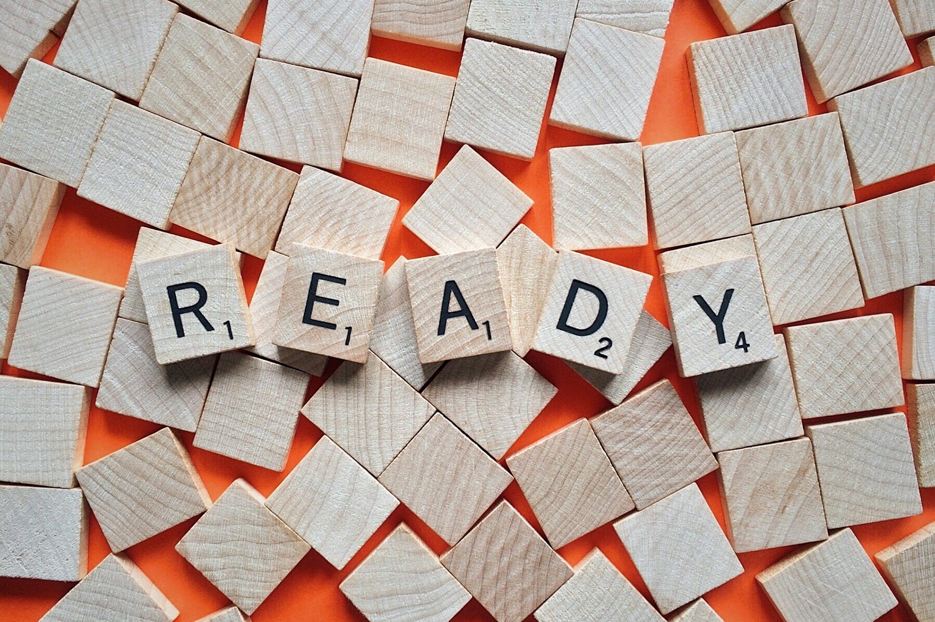 The word ready written with scramble tile symbolizing aa person readiness to buy a house