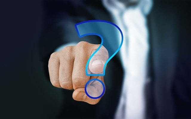A man clicking on the question mark button on a screen