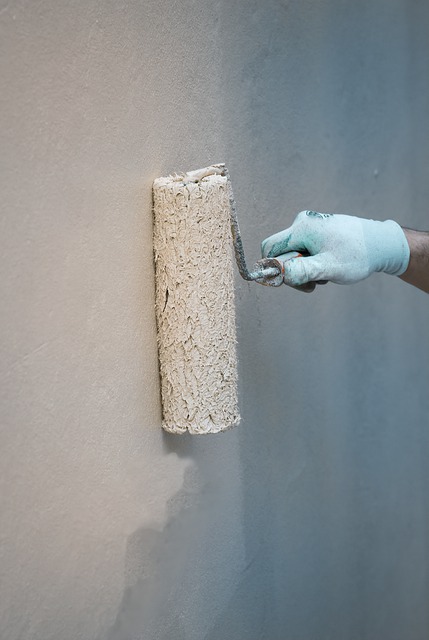 A homeowner painting the wall of the house in order to stage it for sale