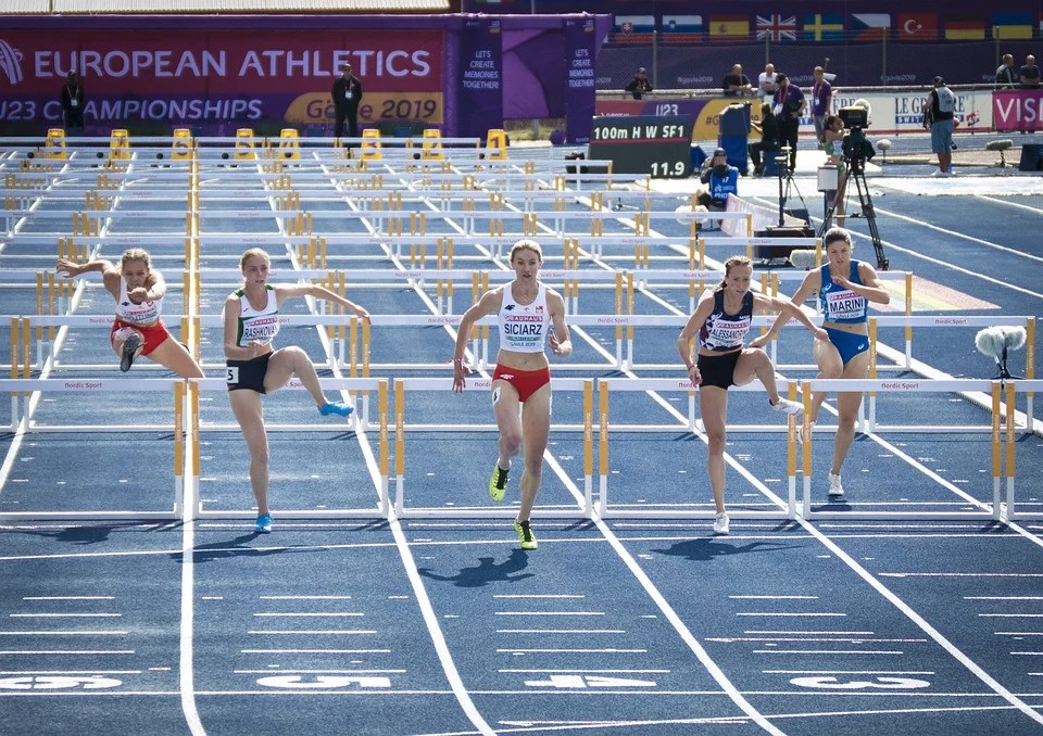 Runners competing to win a hurdle race signifiying the competing nature of bidding wars among homebuyer