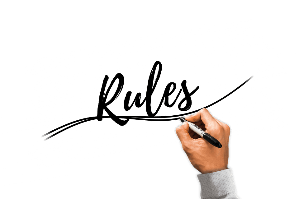 The hand of a real estate agent writing the rules a homebuyer must follow during the home buying process